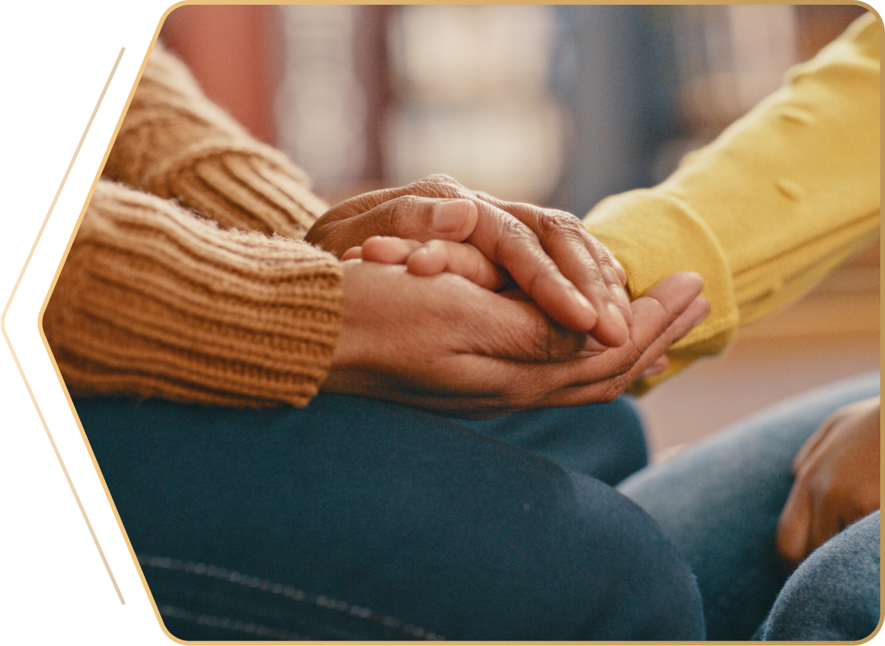 Hands holding in comforting gesture