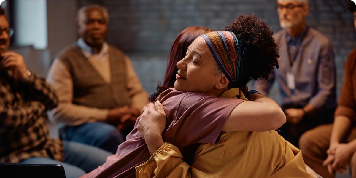 Emotional embrace during a support meeting